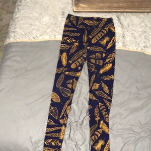 Lula roe one size fits all leggings, purple with feathers on it .